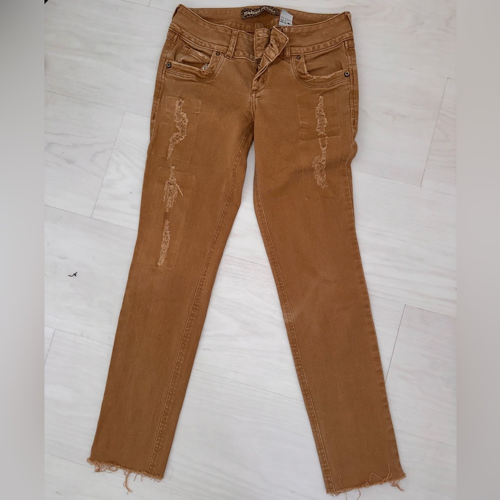 Brown Jeans With Small Rips; the rips don’t show any skin
